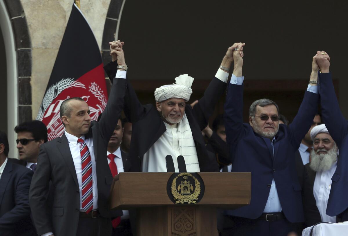 Afghan President Ashraf Ghani is flanked by second Vice President Sarwar Danish, right, and first Vice President Amrullah Saleh at a March 2020 inauguration ceremony at the presidential palace in Kabul.