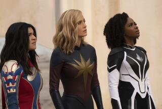 Three women in form-fitting super-hero suits standing  at an angle against a beige background looking ahead
