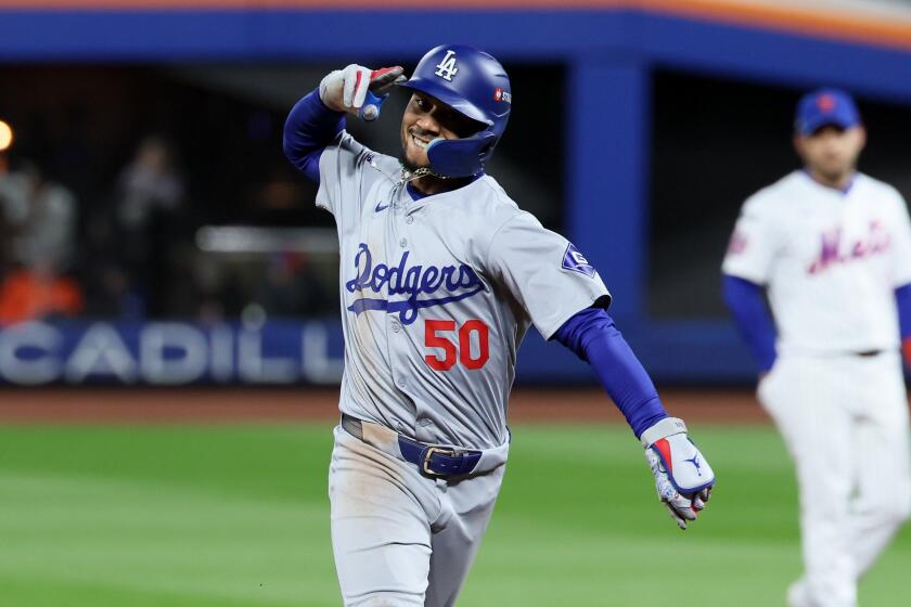 NEW YORK, NEW YORK - OCTOBER 17: Mookie Betts #50 of the Los Angeles Dodgers celebrates while.