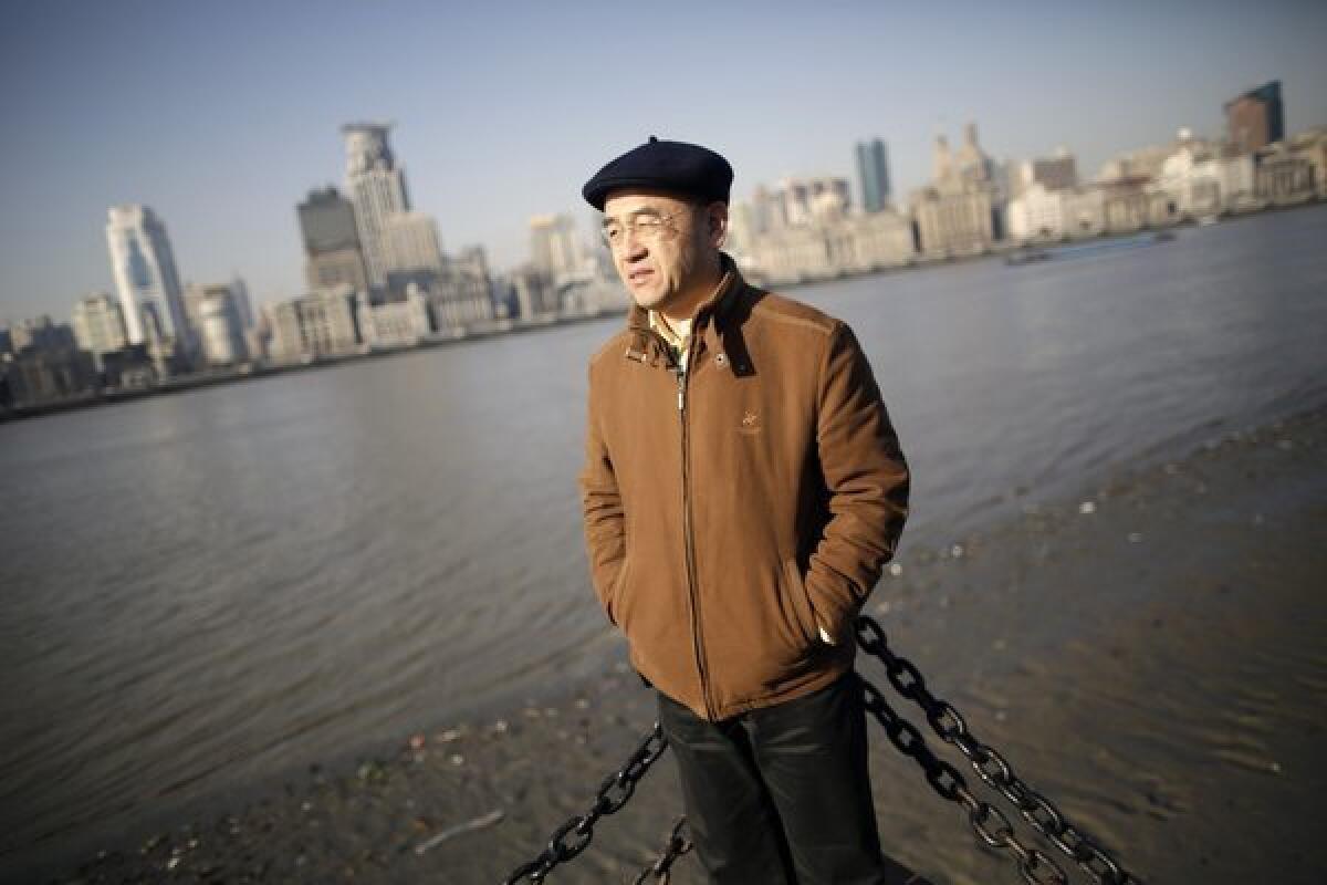 In this Jan. 28, 2013 photo, Chinese-born U.S. scientist Hu Zhicheng stands at the waterfront promenade along the Huangpu River in Shanghai.
