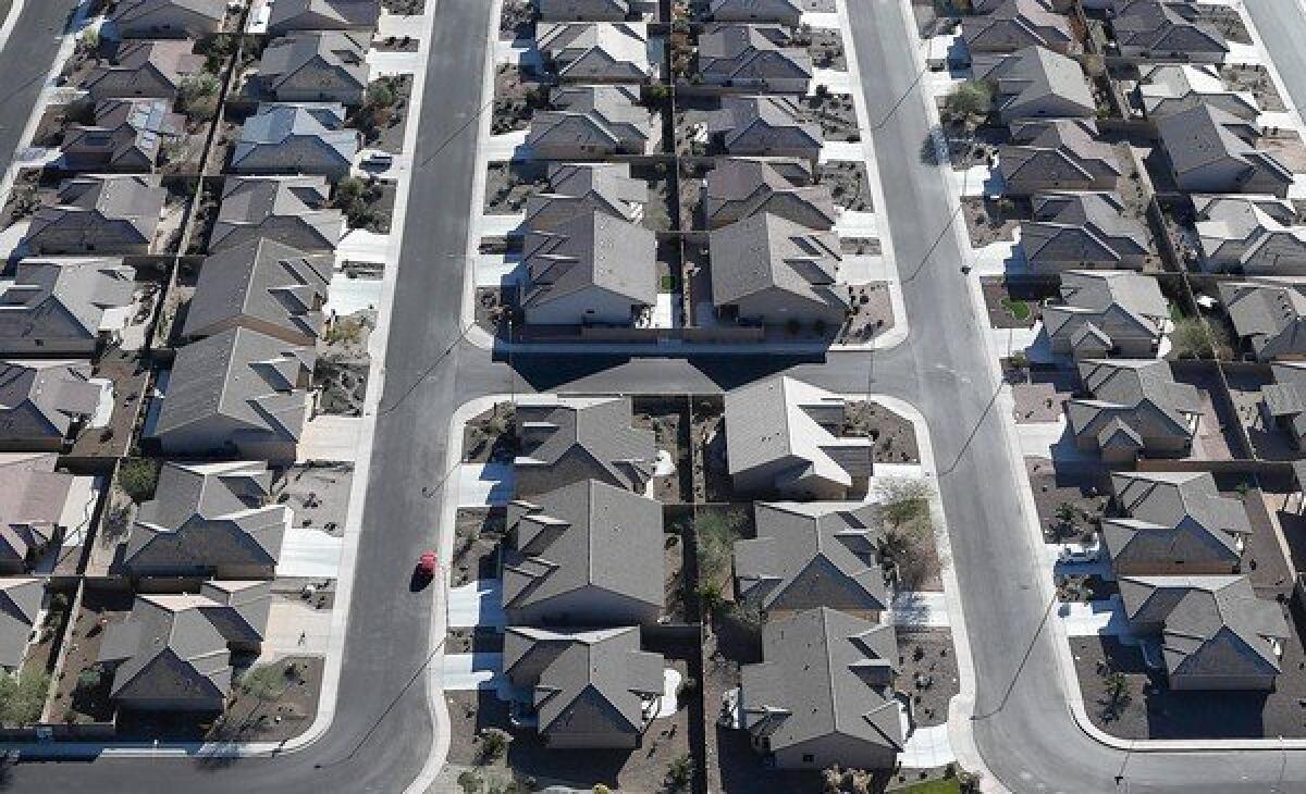 Higher mortgage interest rates could restrain the heavy demand for housing that has driven up home prices recently. Above, rows of homes in a housing development in Mesa, Ariz.