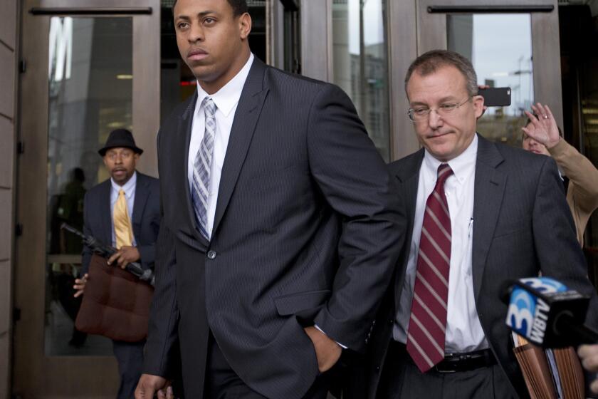 Carolina defensive end Greg Hardy, center, leaves the Mecklenburg County Courthouse in Charlotte, N.C., on Monday after his domestic violence charges were dismissed.