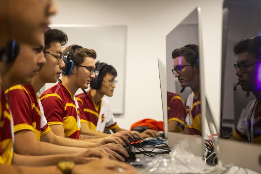 LOS ANGELES, CALIF. - NOVEMBER 12: Members of the USC eSports are reflected in the glass of their monitors as the team holds practice in a lab in the basement of the University of Southern California SCI Building, on Monday, Nov. 12, 2018 in Los Angeles, Calif. (Kent Nishimura / Los Angeles Times)