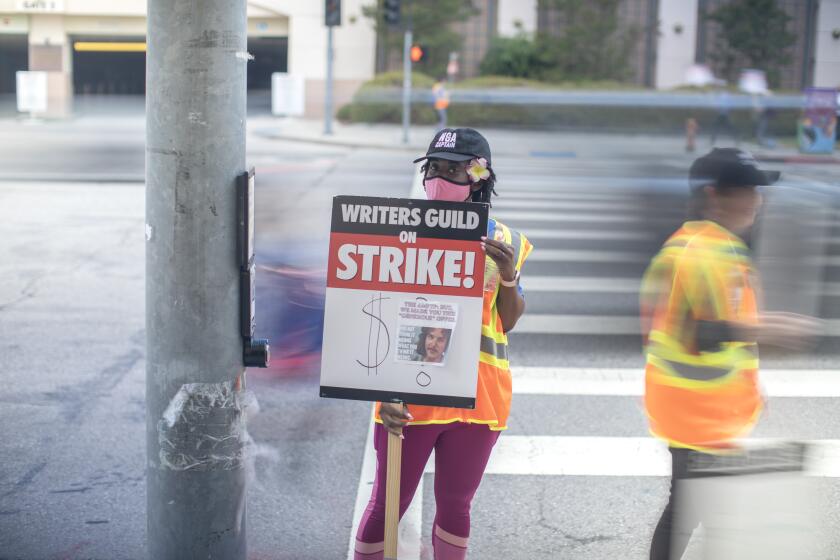 BURBANK, CA - MAY 09: Jackie Penn works the picket line at Warner Bros. Studios in Burbank, CA during the Writers Guild of America strike on Tuesday, May 9, 2023. (Myung J. Chun / Los Angeles Times)