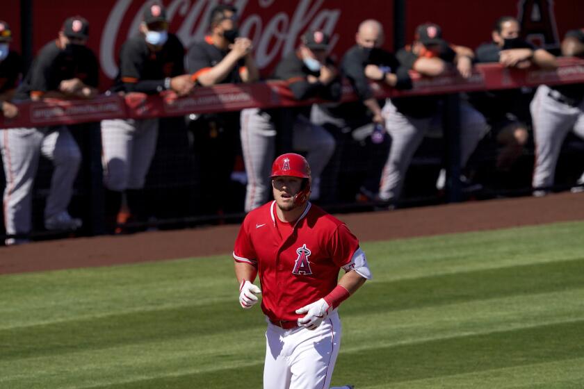 Angels outfielder Mike Trout runs past the Giants' dugout after hitting a two-run home run.