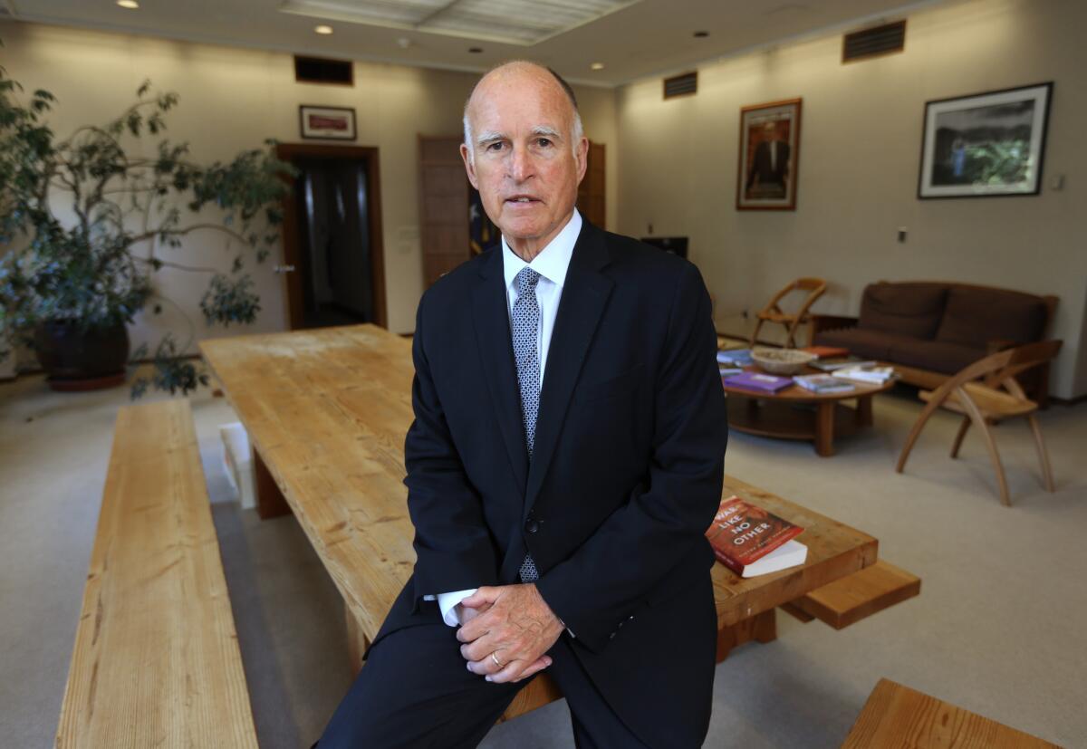 In a new TV ad, Gov. Jerry Brown for the first time makes an explicit argument for his election to an unprecedented fourth term. Above, Brown poses for a photo in his Capitol office in May.