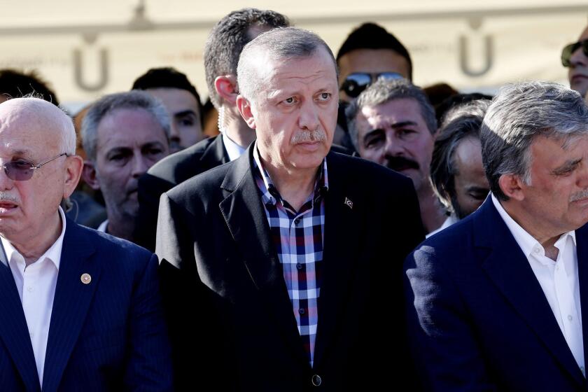 Turkish President Recep Tayyip Erdogan (center), along with the nation's current parliamentary speaker Ismail Kahraman (left) and former president Abdullah Gul (right), attends a funeral in Istanbul for some of those killed in last week's coup attempt.