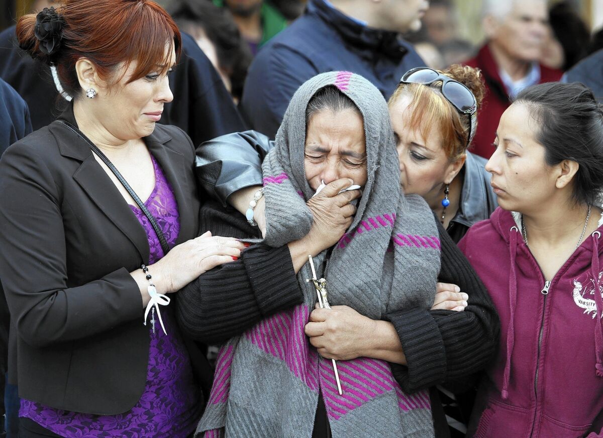 Agapita Montes Rivera, the mother of Antonio Zambano Montes, is comforted after her son's funeral on Feb. 25 in Pasco, Wash.