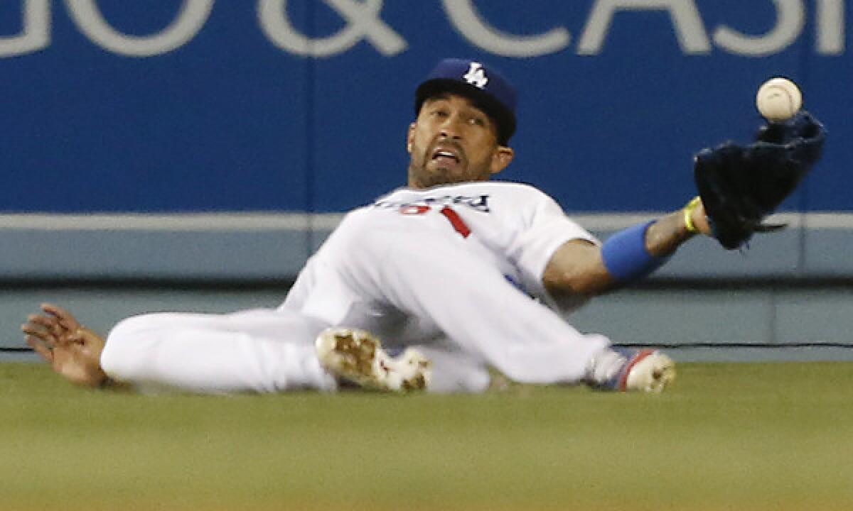 Dodgers center fielder Matt Kemp can't come up with a catch on a run-scoring single by Detroit's Victor Martinez during the ninth inning of Tuesday's game. The Dodgers went on to win the game in the 10th inning, 3-2.
