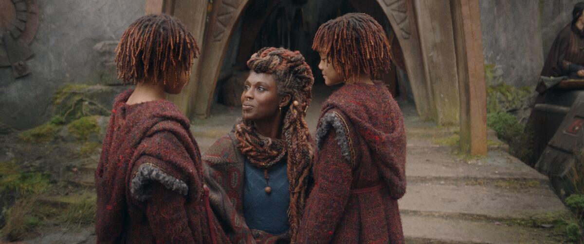 Jodie Turner-Smith kneels and talks to her young twin daughters, played by Lauren and Leah Brady, in "The Acolyte."