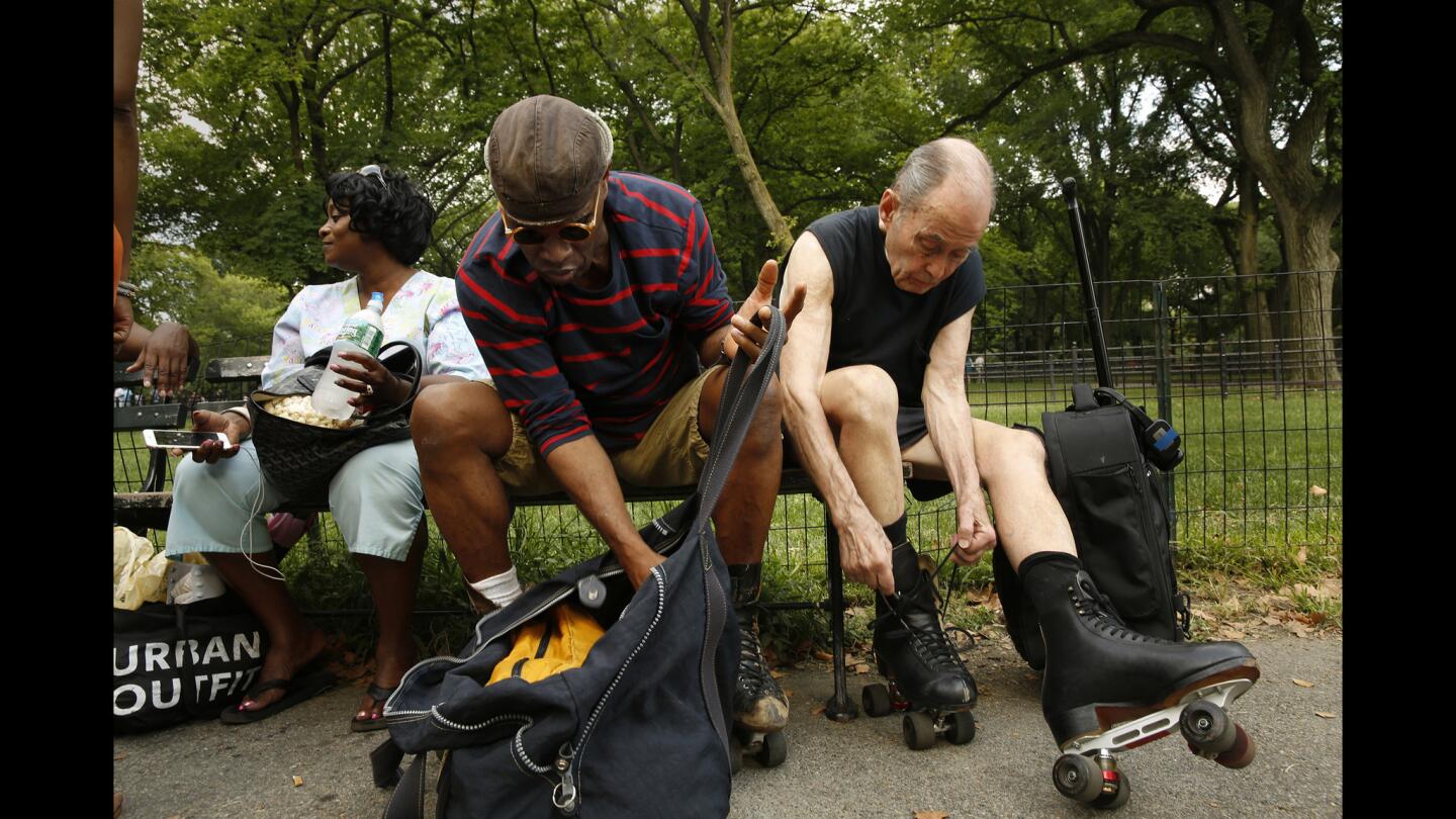 Lewis Hamilton, 61, left, and Joseph Byrne, 81, lace up before skating in New York's Central Park.