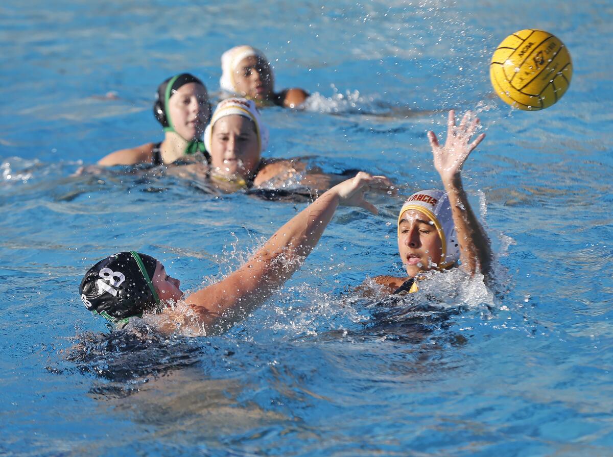 Costa Mesa's Mikaela Smith (18) shoots and scores during Battle for the Bell girls' water polo on Tuesday.