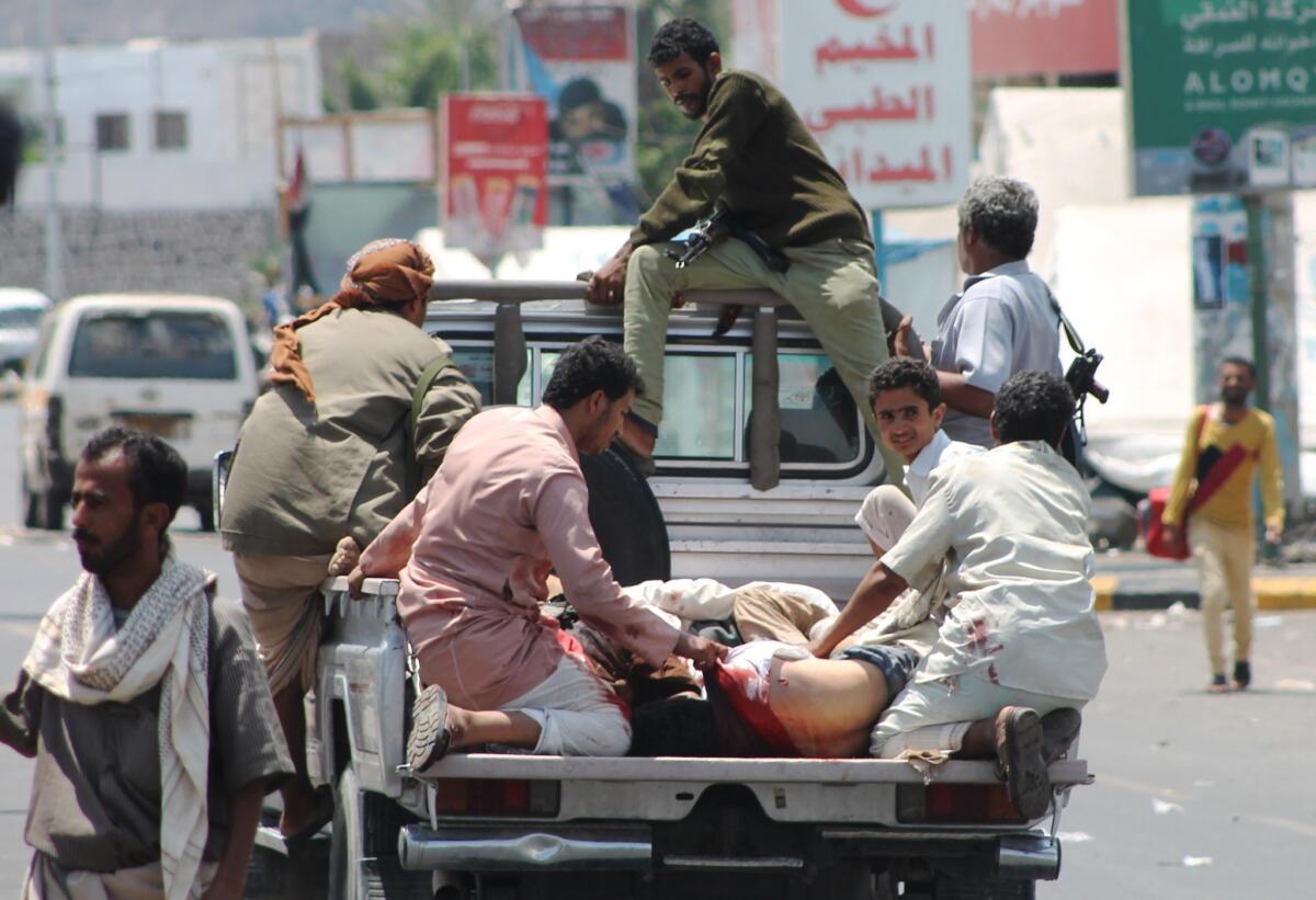 Yemeni men tend to the wounded in a pickup in the southern port city of Aden on March 26.