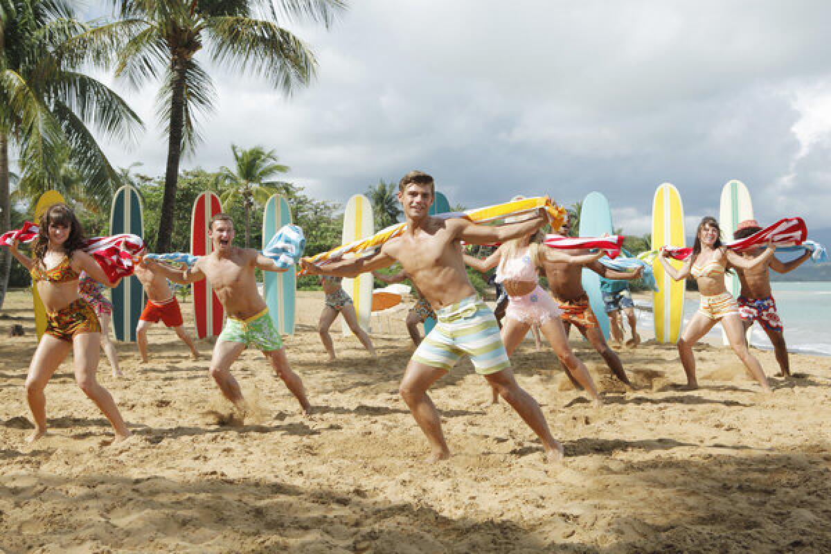 Garrett Clayton, center, and the cast of "Teen Beach Movie," which premieres at 8 tonight on the Disney Channel.