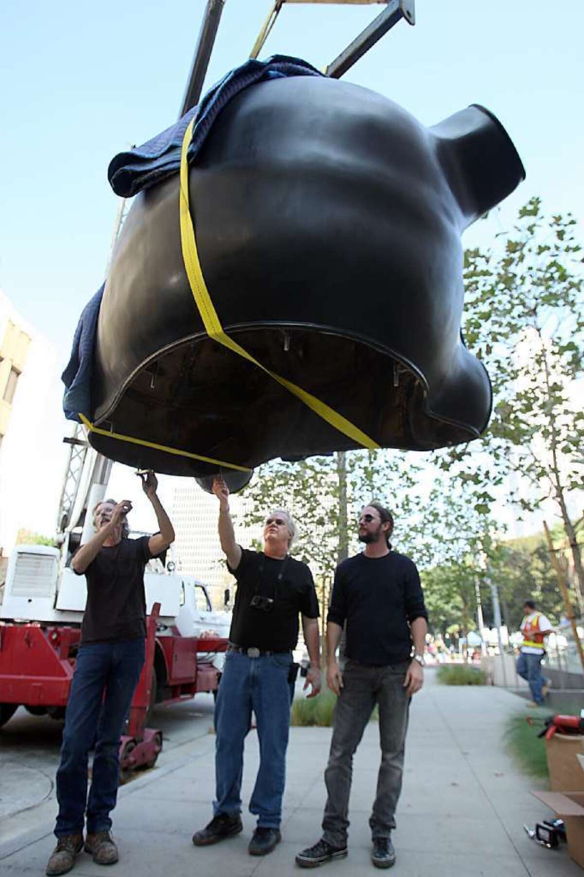 Peter Shelton, center, oversees installation of a segment of his public sculpture "Six Beasts Two Monkeys" outside the Los Angeles Police Department's headquarters in 2009. L.A. officials are trying to figure out how to untie a legal knot that's preventing $7.5 million from being spent on other public artworks.