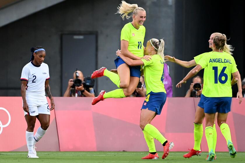 -SP- July 21, 2021: Sweden's Stina Blackstenius jumps into the arms of a teammate after scoring a goal against USA in the first half in a Group G game at the 2020 Tokyo Olympics. (Wally Skalij /Los Angeles Times)
