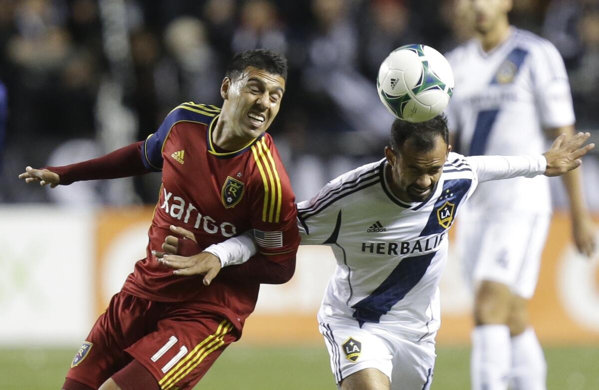 Juninho, right, then a Galaxy midfielder, battles with Real Salt Lake's Javier Morales for the ball during a playoff game in 2013.