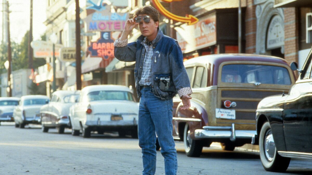 Michael J Fox walkS across the street in a scene from the film "Back To The Future," 1985.