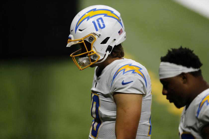 Los Angeles Chargers quarterback Justin Herbert (10) walks off the field after losing to the New Orleans Saints in overtime of an NFL football game in New Orleans, Monday, Oct. 12, 2020. The Saints won 30-27. (AP Photo/Brett Duke)