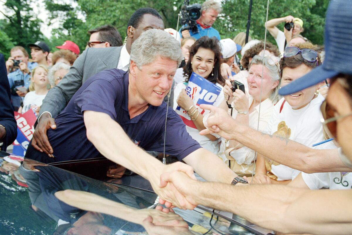 Bill Clinton shakes supporters' hands during a presidential campaign stop in Carrollton, Ky., in July 1992. 