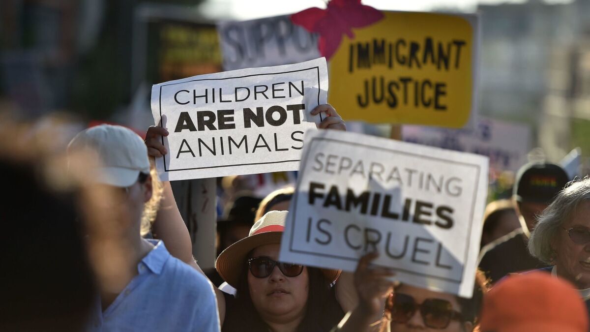 Critics of the government policy that separates children their parents when they cross the border illegally protest during a "Families Belong Together March" in downtown Los Angeles on Thursday.