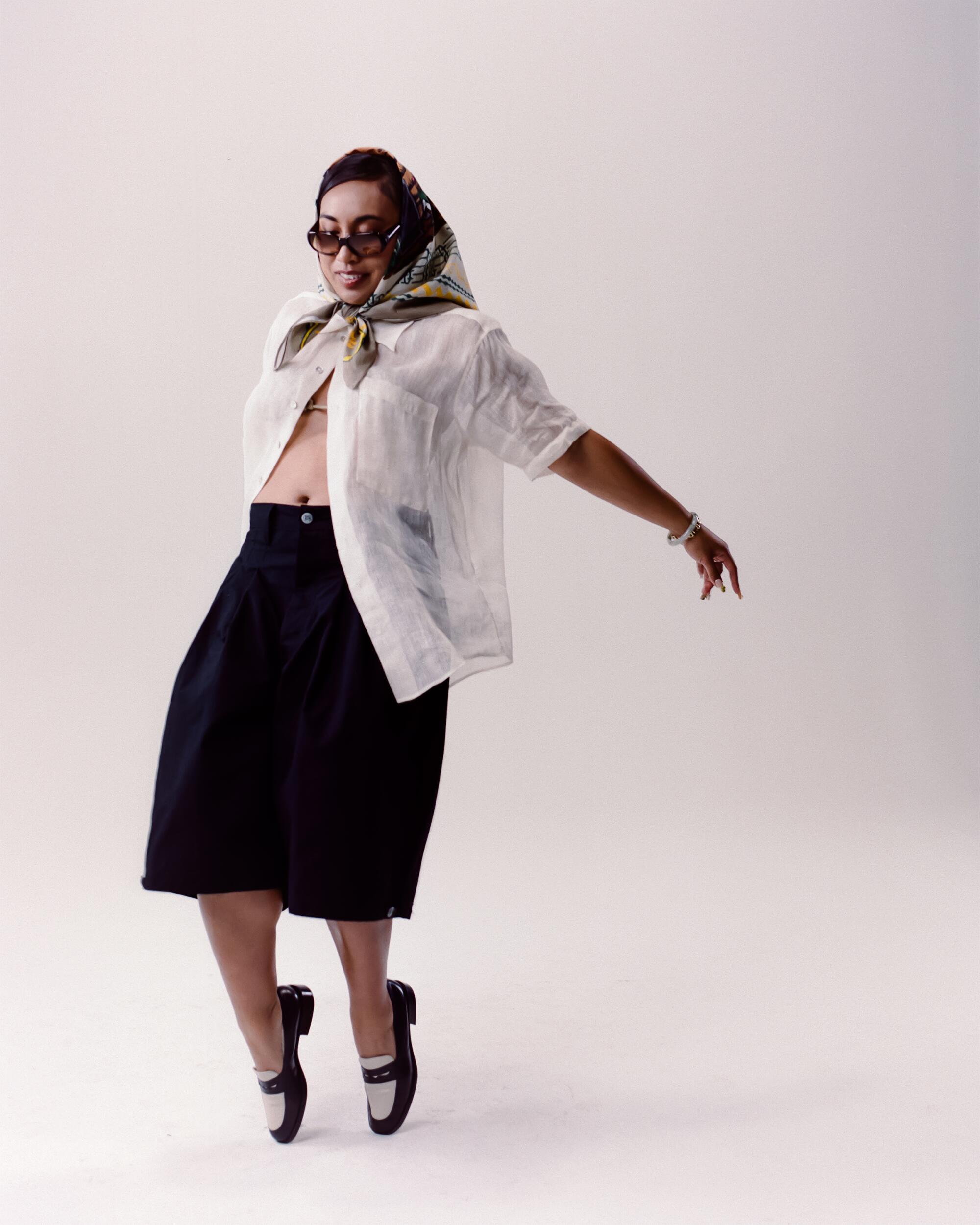 Micah wears Ballads Bobby Glenn bandanna, Maaari Piña button-up, Art Community Anorak jorts, vintage Fendi sunglasses from