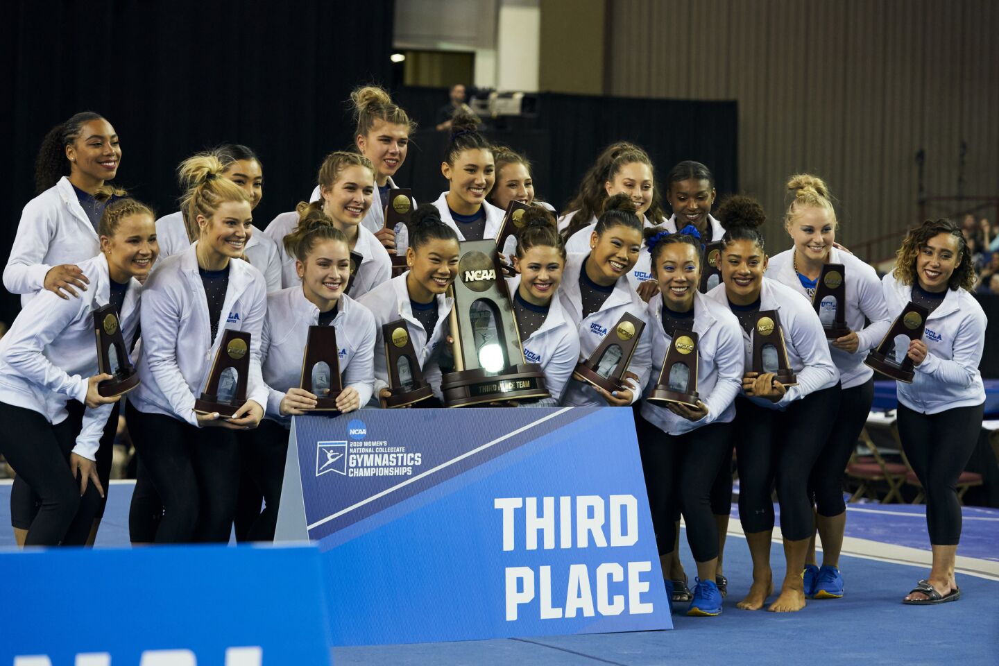 The Bruins celebrate after finishing third at the NCAA championship Saturday in Fort Worth, Texas.