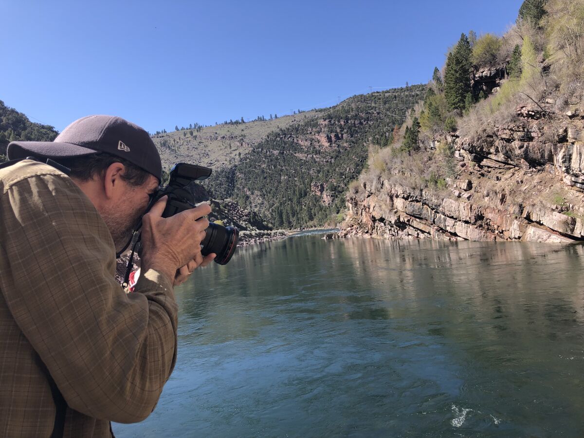 L.A. Times photographer Robert Gauthier takes pictures of trout at the foot of Flaming Gorge Dam.