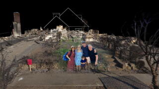 A family amid fire devastation in a VR film.