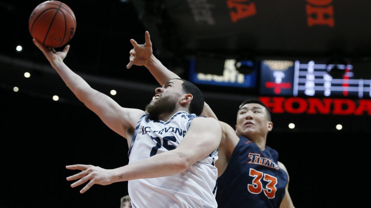 UC Irvine guard Spencer Rivers, left, puts up a shot against Cal State Fullerton forward Johnny Wang during the second half of the Big West conference championship game in Anaheim on Saturday.