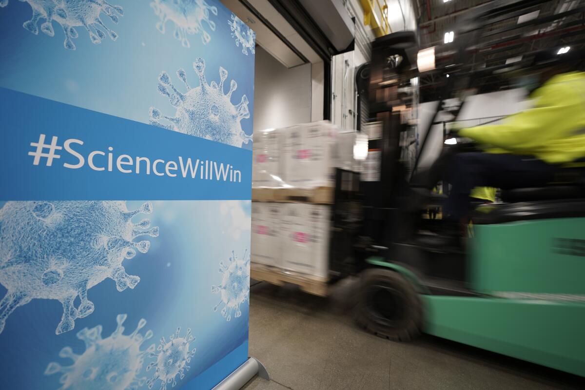 A forklift moves boxes past a sign that says "Science Will Win."