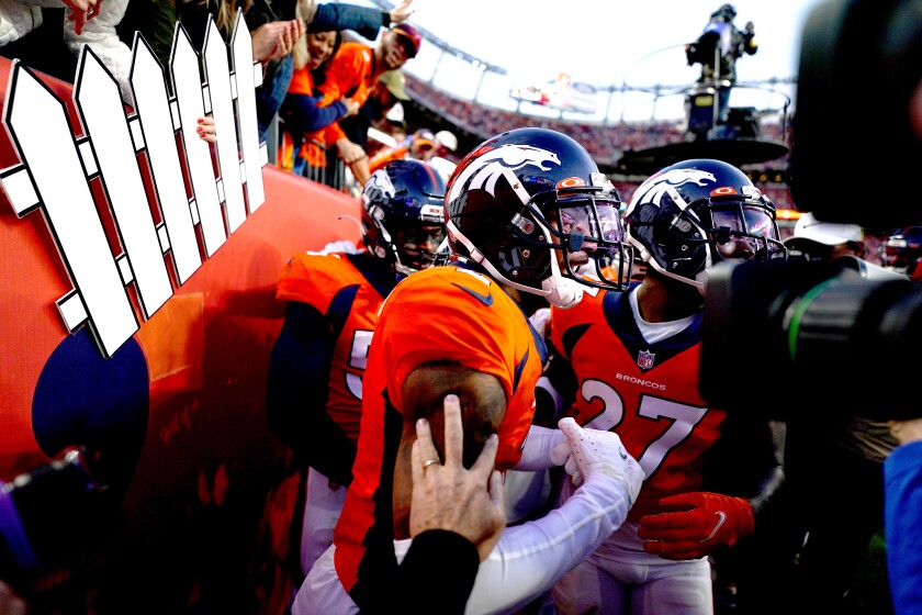 Denver Broncos cornerback Patrick Surtain II, center, celebrates his interception against the Chargers.