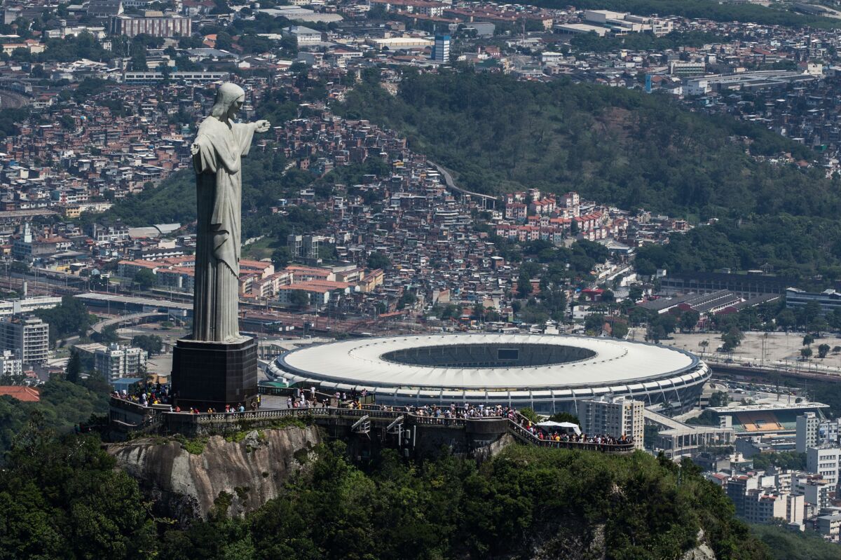 The Christ the Redeemer statue stands above the Maracana stadium in Rio de Janeiro.