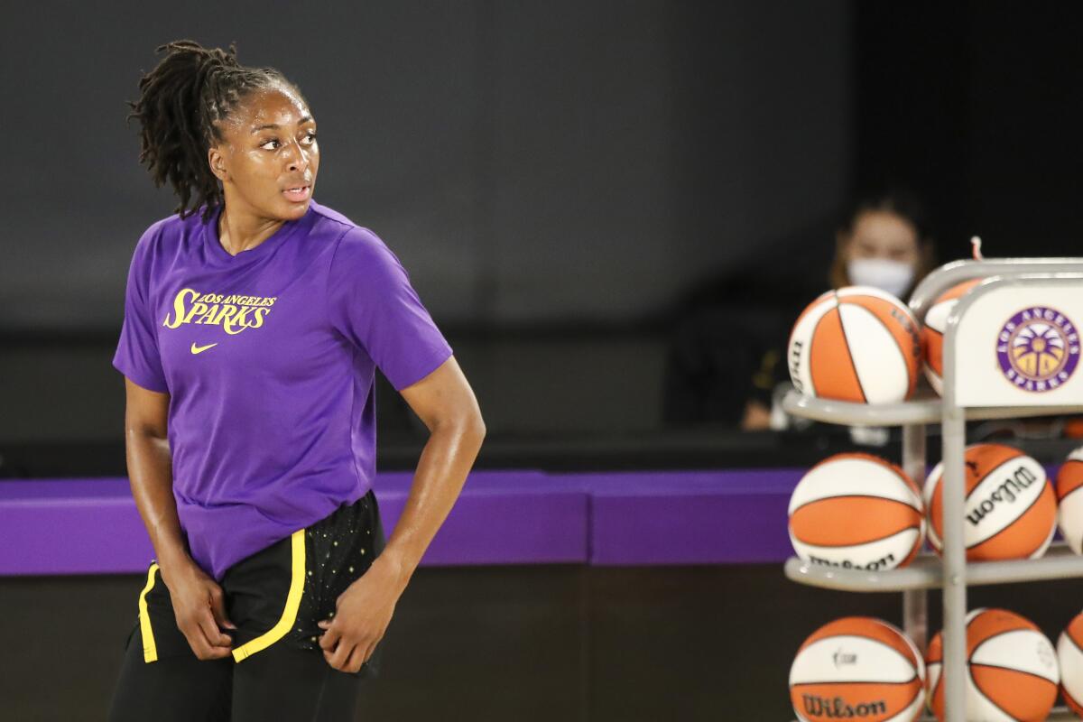 Sparks forward Nneka Ogwumike adjusts her gear as she prepares to warm up before a game.