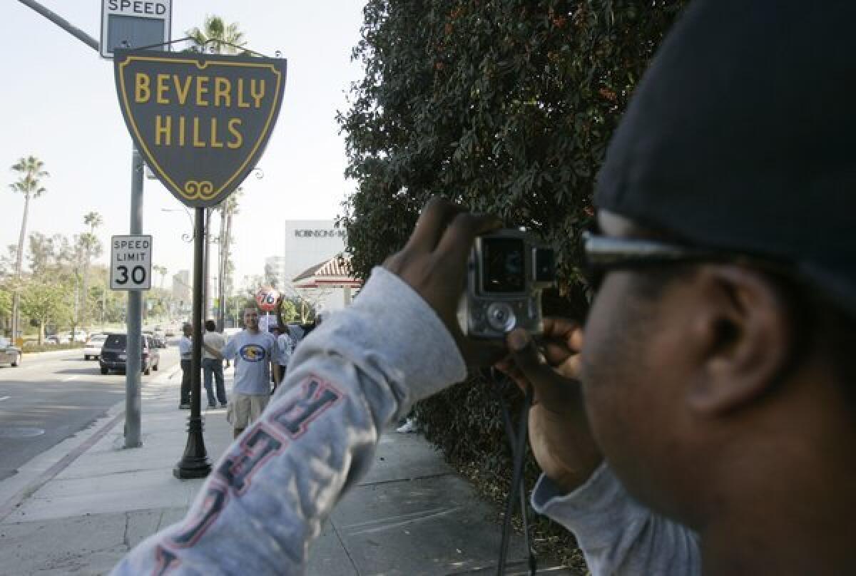 Snapping a photo in front of the Beverly Hills sign.