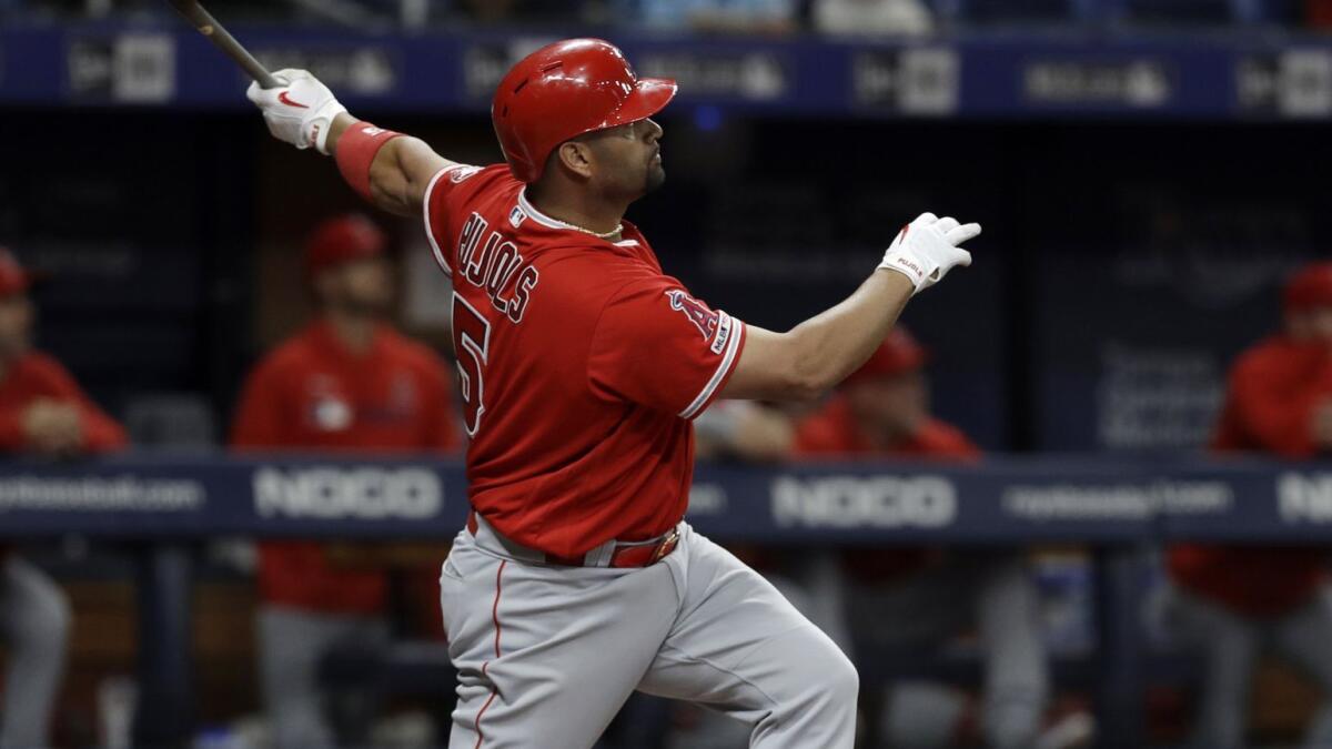 Angels' Albert Pujols watches his two-run home run off Tampa Bay Rays' Ryan Yarbrough during the fifth inning on Thursday in St. Petersburg, Fla.