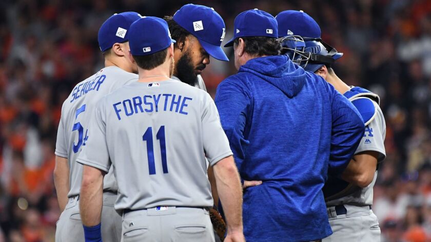 Dodgers closer Kenley Jansen meets at the mound with pitching coach Rick Honeycutt during Game 5 of the World Series against Houston on Oct. 29.