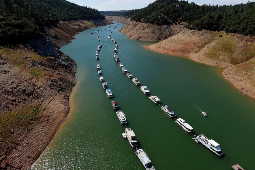 Houseboats are moored on a shrinking arm of the Oroville Lake reservoir, which is now at 25% capacity because of the drought.