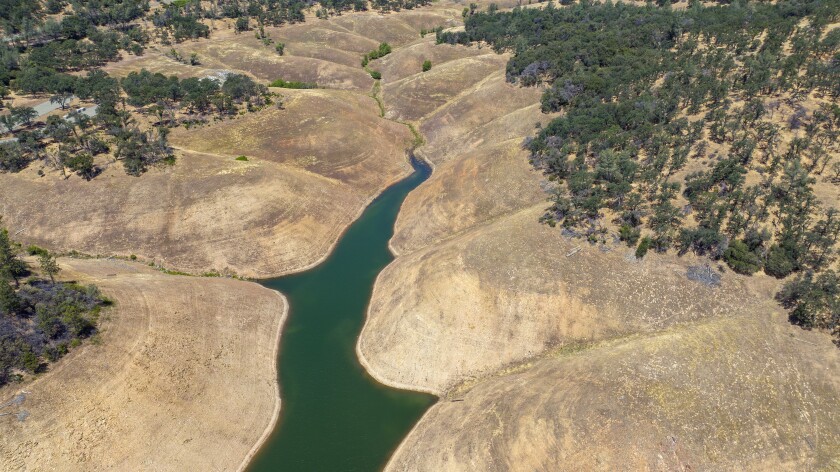 Large bare shorelines surrounding a shrinking body of water