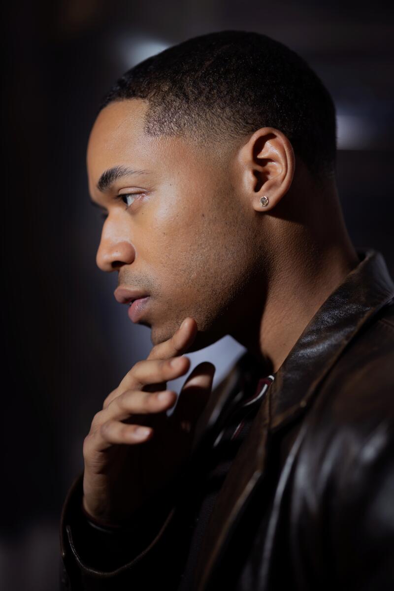 A profile headshot of Kelvin Harrison Jr. with his hand near his chin.