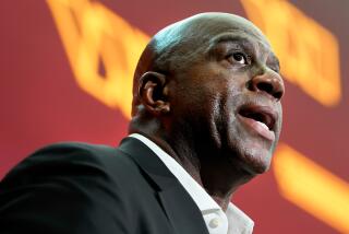 Magic Johnson, a member of the group buying the Washington Commanders, speaks at  news conference at FedEx Field