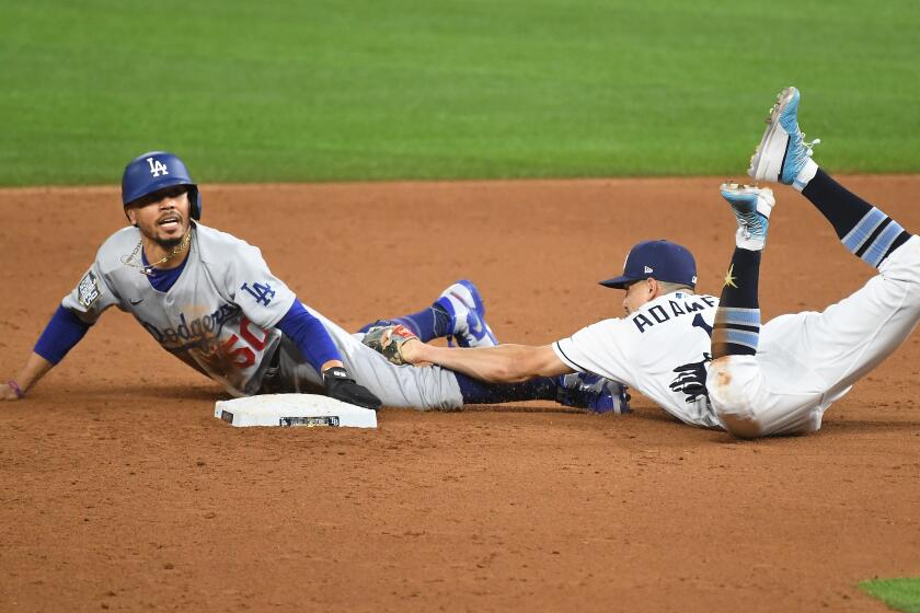 ARLINGTON, TEXAS OCTOBER 23, 2020-Dodgers Mookie Betts steals second base in front of Rays shortstop Willy Adames in the 6th inning in Game 3 of the World Series at Globe Life Field in Arlington, Texas Friday. (Wally Skalij/Los Angeles Times)