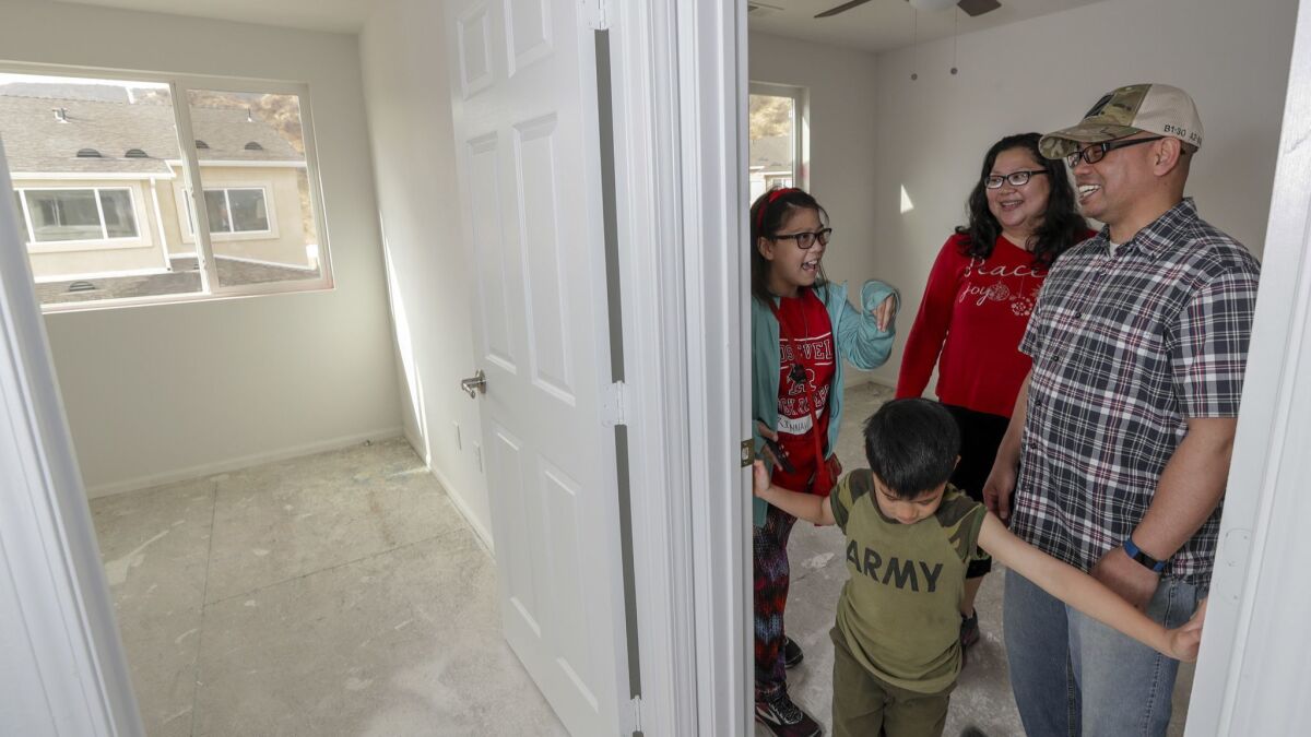 Iraq war veterans Marlon and Josette Tolentino, with their children Rinnah, 14, and Marcus, 6, check out their future home in a community of single-family houses built in Santa Clarita for veterans and service members.