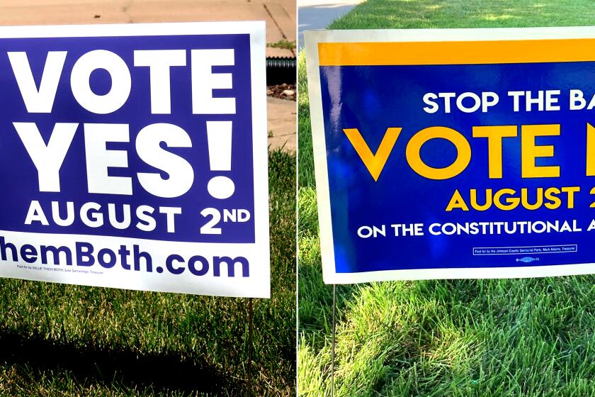 LEFT: In this photo from Friday, July 8, 2022, a sign in a yard in Olathe, Kansas, promotes a proposed amendment to the Kansas Constitution to allow legislators to further restrict or ban abortion. RIGHT: In this photo from Thursday, July 14, 2022, a sign in a yard in Merriam, Kansas, urges voters to oppose a proposed amendment to the Kansas Constitution to allow legislators to further restrict or ban abortion.