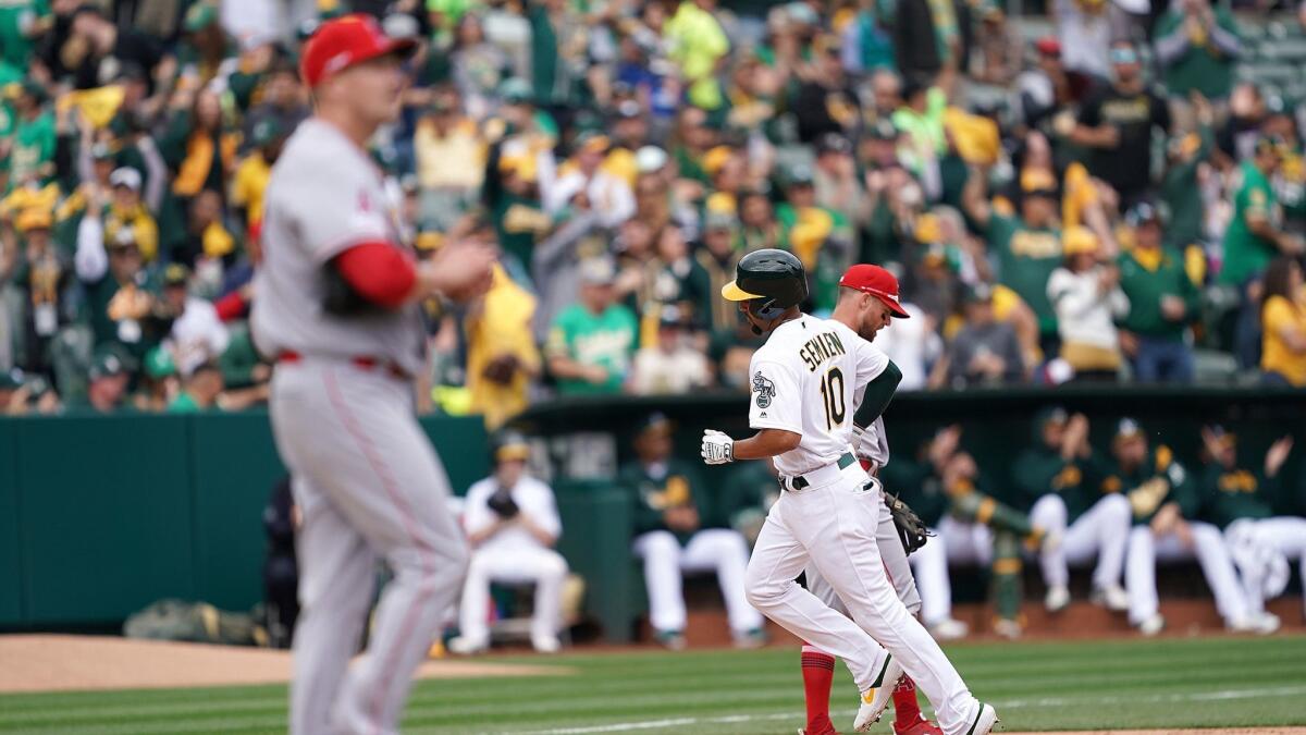Marcus Semien (10) of the Oakland Athletics trots around the bases after hitting a solo home run off of Trevor Cahill (53) of the Angels in the bottom of the fourth inning.