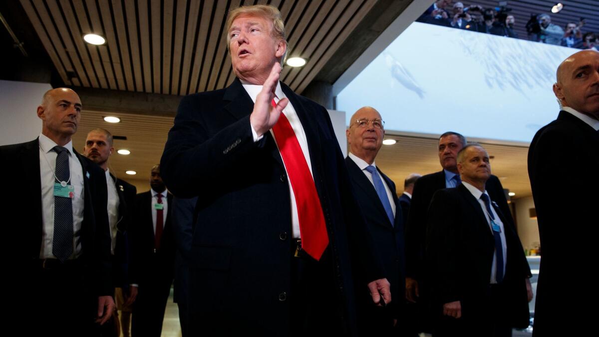 President Donald Trump talks with reporters as he arrives at the World Economic Forum in Davos, Switzerland on Jan. 26, 2018.