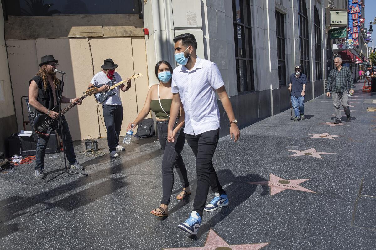 Pedestrians walk along Hollywood Boulevard in Hollywood.