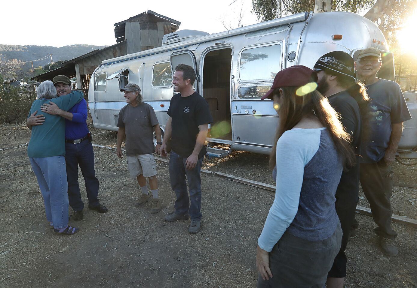 Daniel Vasquez, second from left, receives a hug from Mary Bryan after learning that an Airstream trailer became available for him to live in. His trailer was destoryed in the Thomas fire.