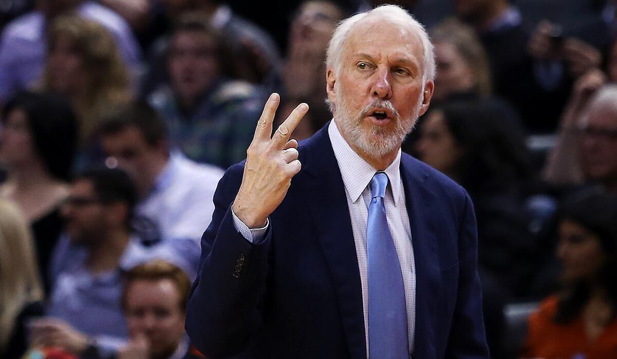 San Antonio Spurs Coach Gregg Popovich gestures from the bench during a game against the Toronto Raptors.