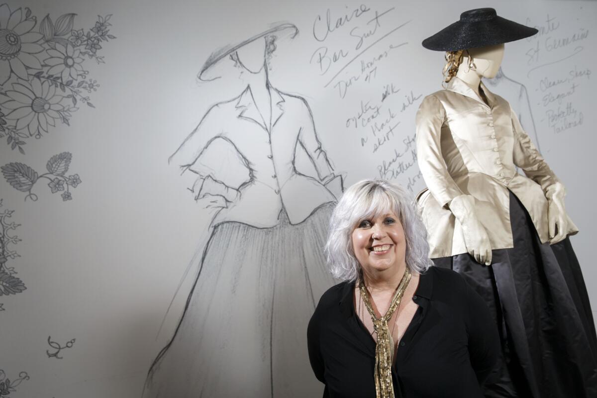 Terry Dresbach, costume designer for the Starz historical drama "Outlander," poses with a costume at "The Artistry of 'Outlander'" exhibition at the Paley Center for Media in Beverly Hills.
